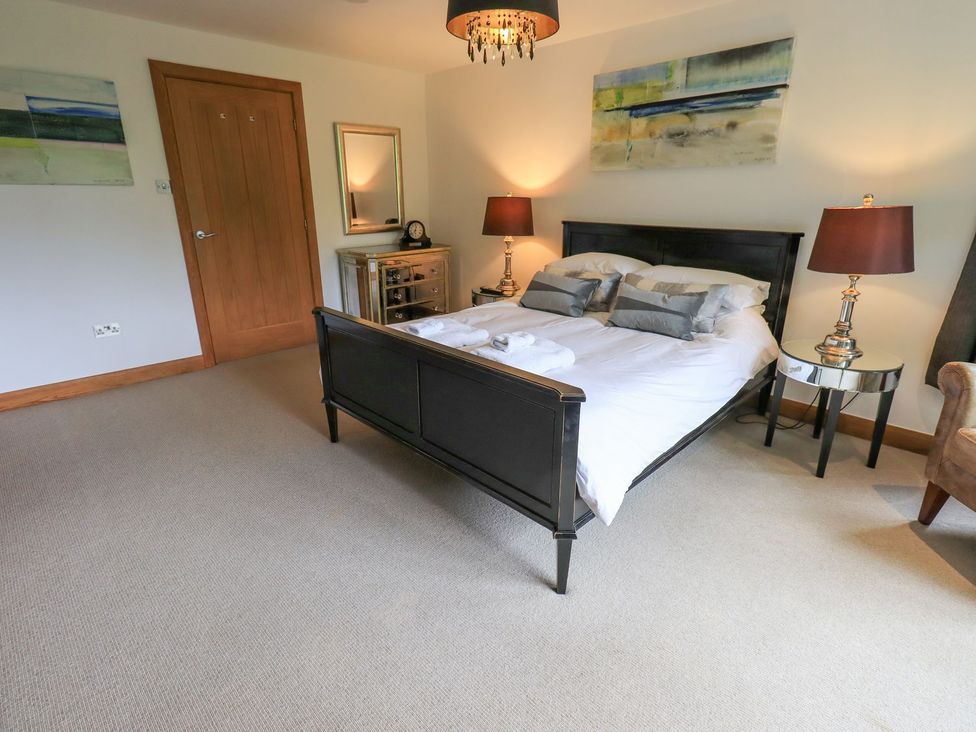 A bedroom with a bed and lamps at Bracken Ground in Coniston