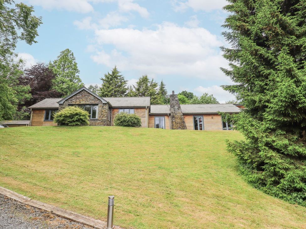 A house with a lawn and trees at Bracken Ground in Coniston