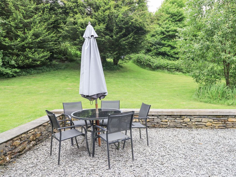 An outdoor dining area with a table and chairs at Bracken Ground in Coniston