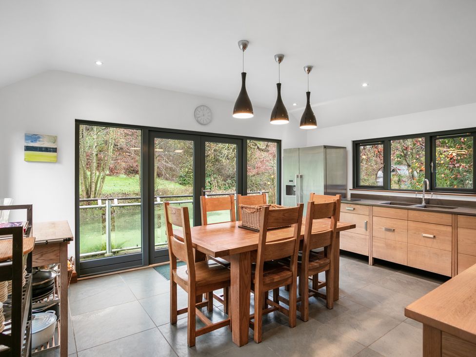 A kitchen with a dining table and fridge at Bracken Ground in Coniston