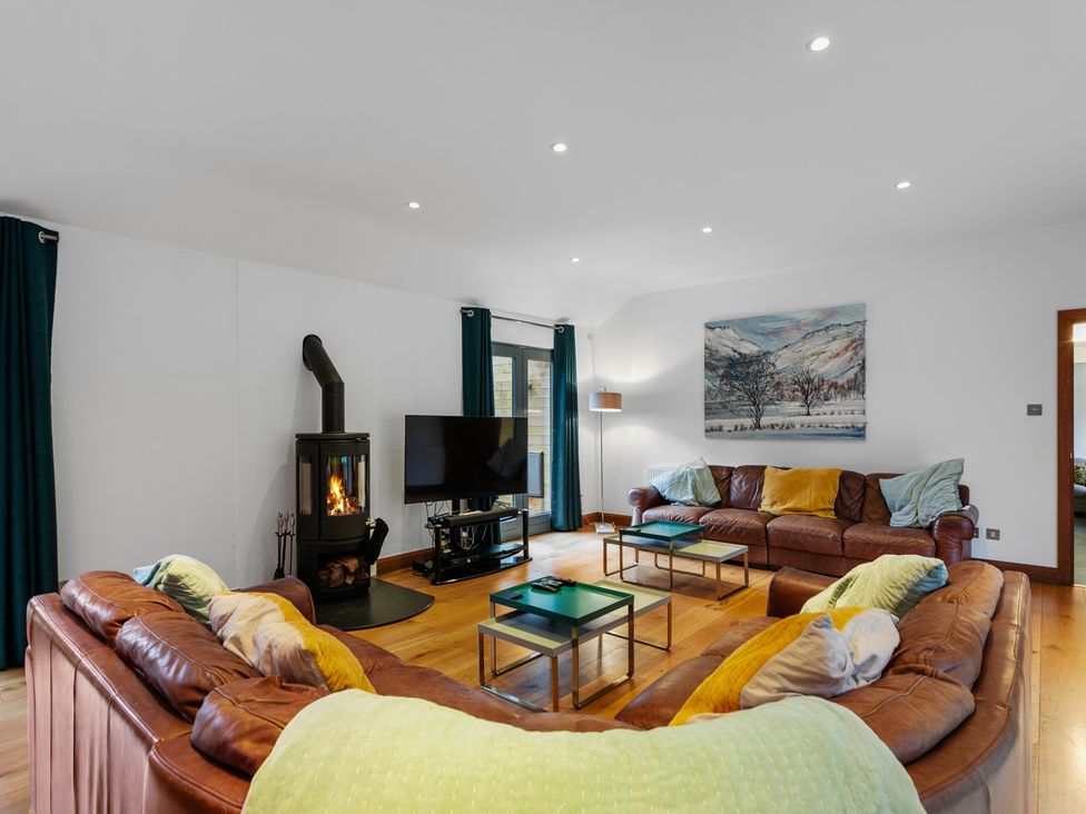 A living room with a sofa and television at Bracken Ground in Coniston