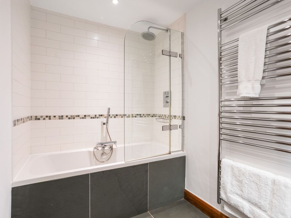 A bathroom with a bathtub and shower at Bracken Ground in Coniston
