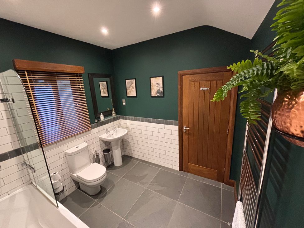 A bathroom with a toilet, sink, and shower at Bracken Ground in Coniston