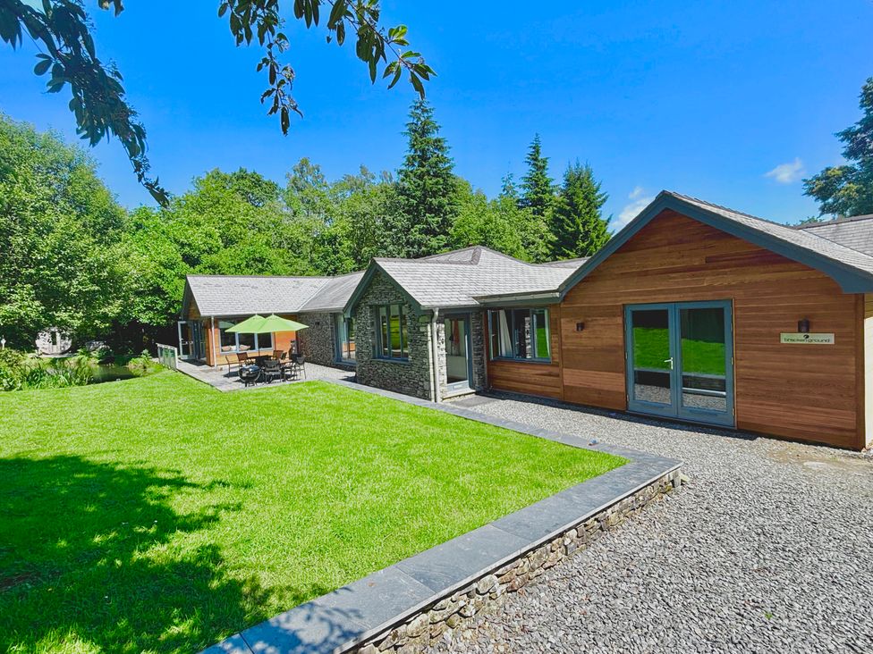 A house with a lawn and outdoor furniture at Bracken Ground in Coniston