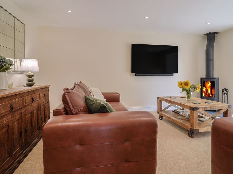 A living room with a sofa and a coffee table at Foxes Den in Pendomer near Yeovil, Somerset