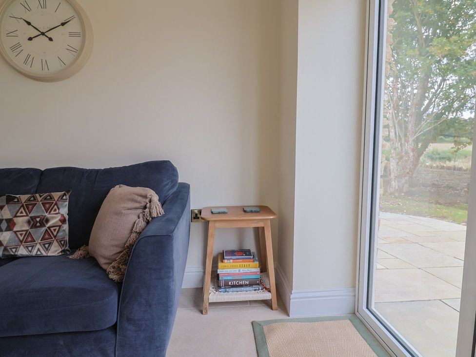 A living room with a sofa and side table at Foxes Den, Pendomer near Yeovil, Somerset