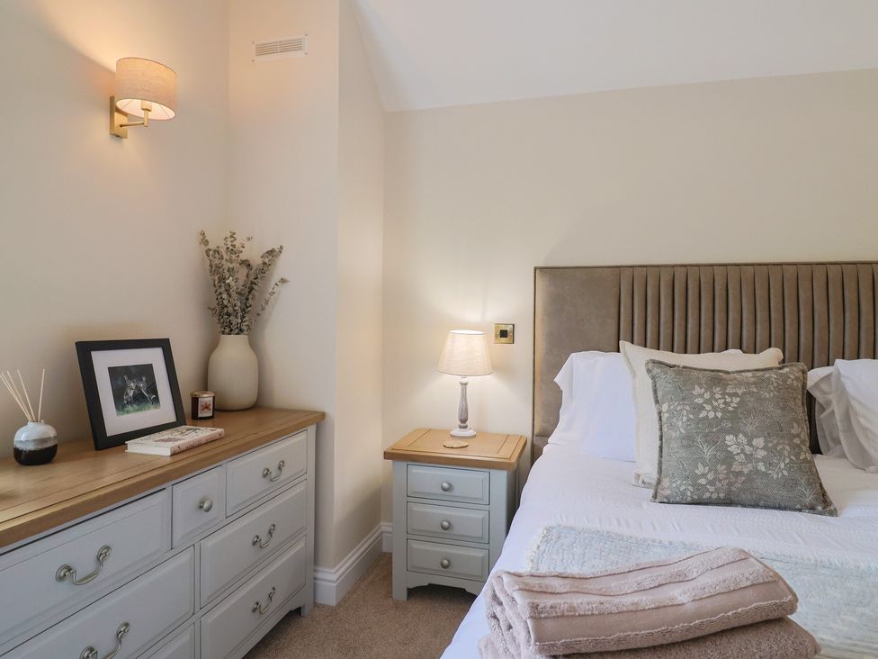 A bedroom with a bed and nightstand at Foxes Den Pendomer near Yeovil, Somerset