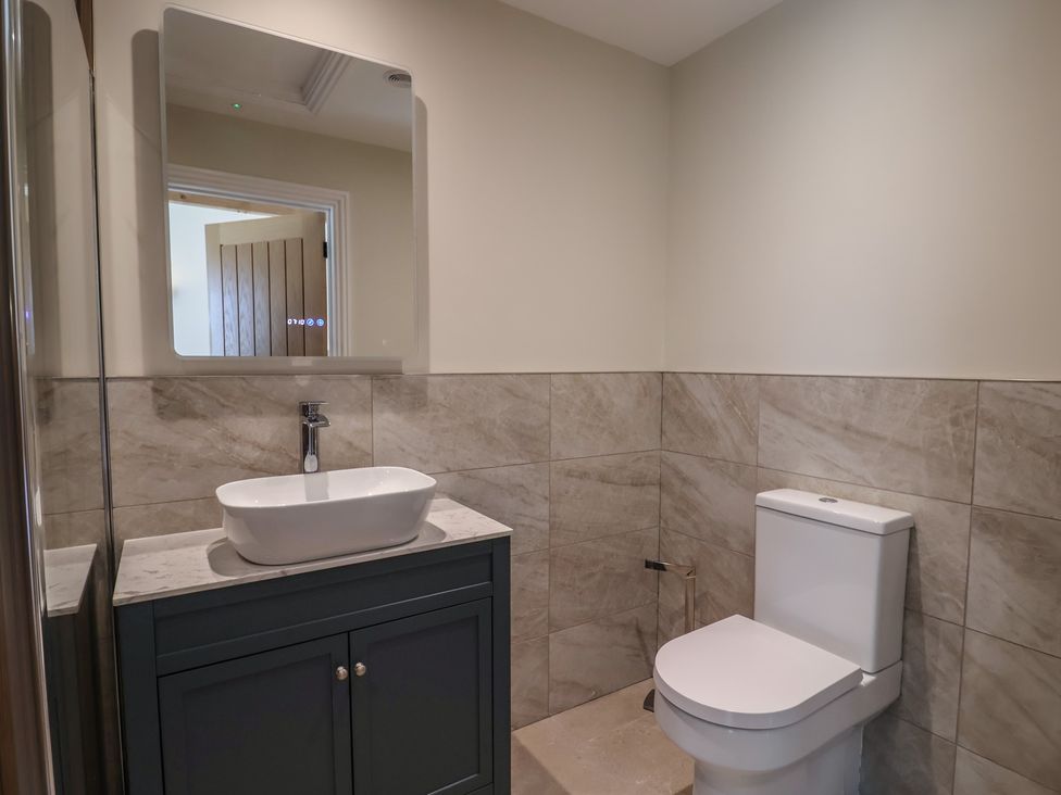 A bathroom with a sink and toilet at The Fox Den in East Coker