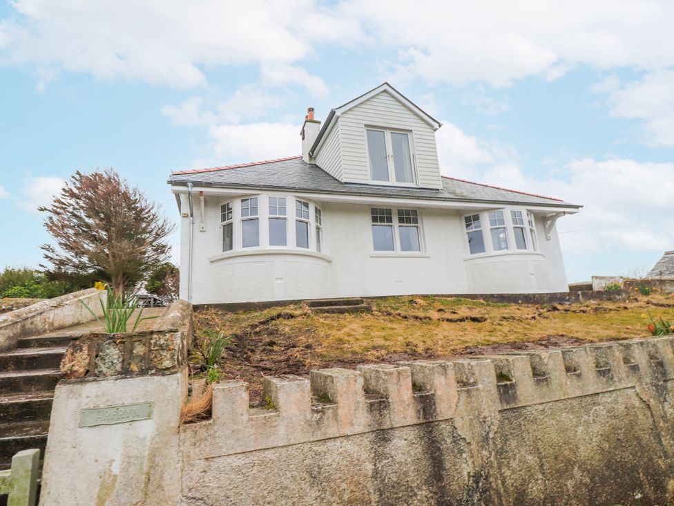 A house with multiple windows and steps at 4 bed in Anglesey