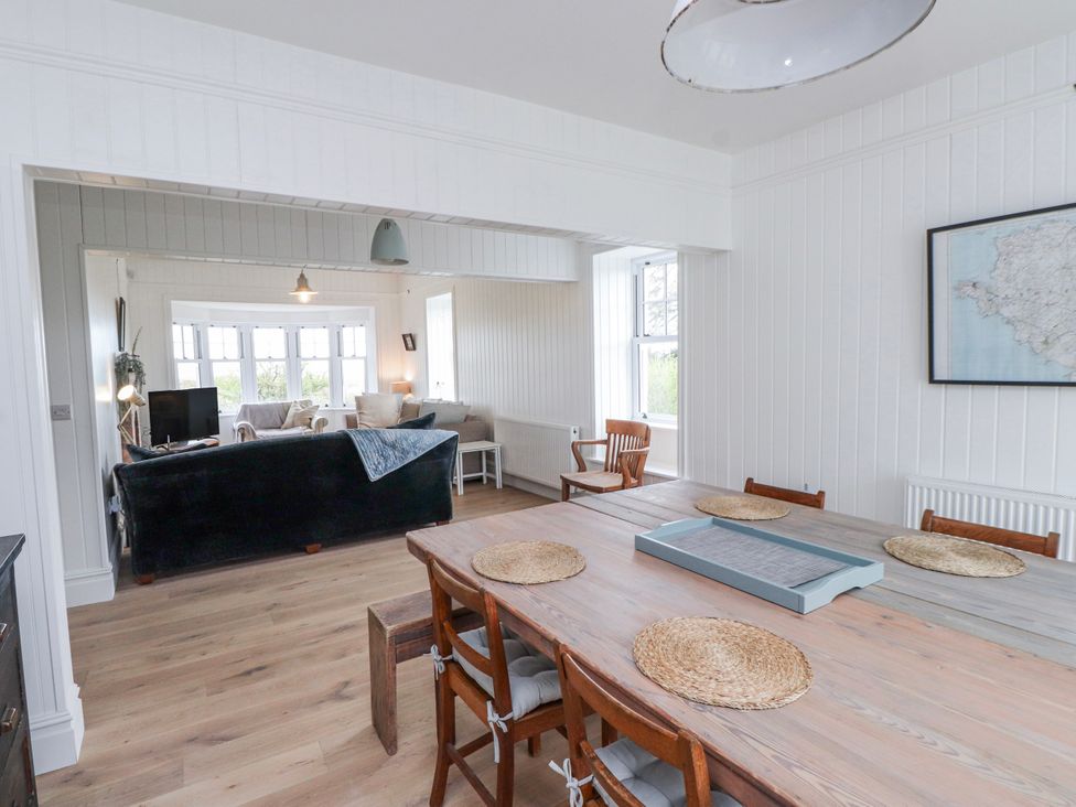 A dining room with a large table and chairs at 4 bed in Anglesey