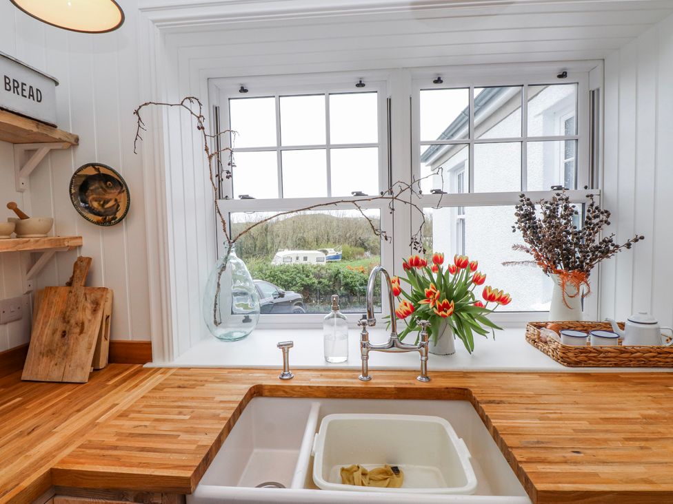 A kitchen with a sink and window at 4 bed in Anglesey