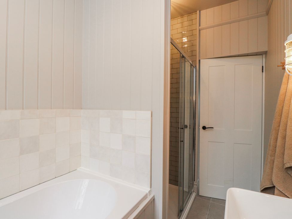 A bathroom with a bathtub and shower at 4 bed in Anglesey