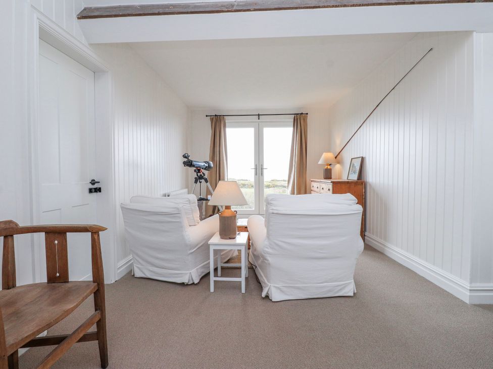 A living room with a telescope and a lamp at 4 bed in Anglesey