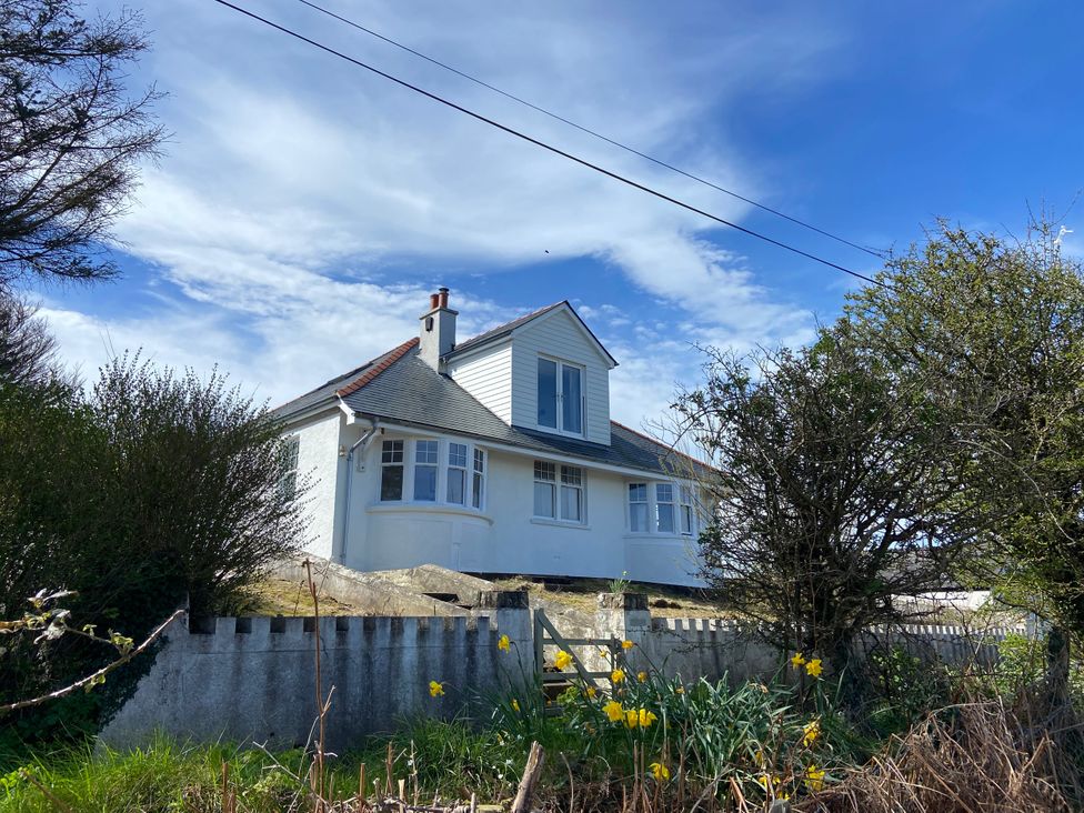 A house surrounded by trees and a fence at Arfryn
