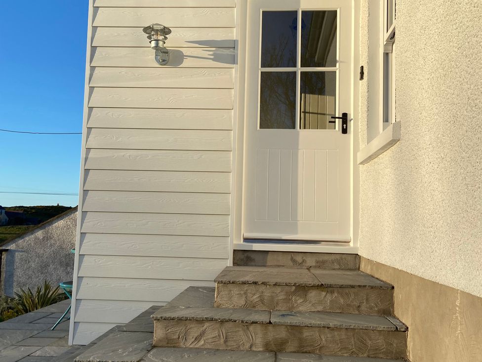 A door with steps at Arfryn in Bull Bay