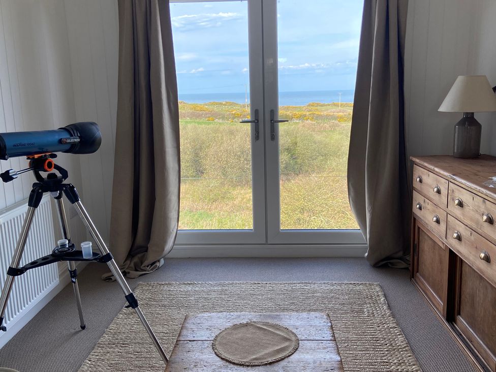 A room with a telescope and a view of the sea at Arfryn, Bull Bay