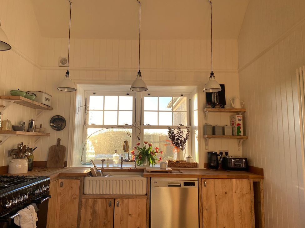 A kitchen featuring a sink and window at Arfryn Bull Bay