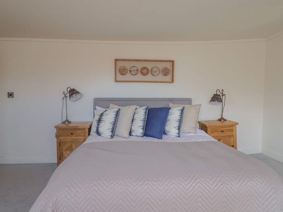 A bedroom with a bed and bedside tables at FLAT 3 54a broad Street (2 bed sleeping 4) Lyme Regis