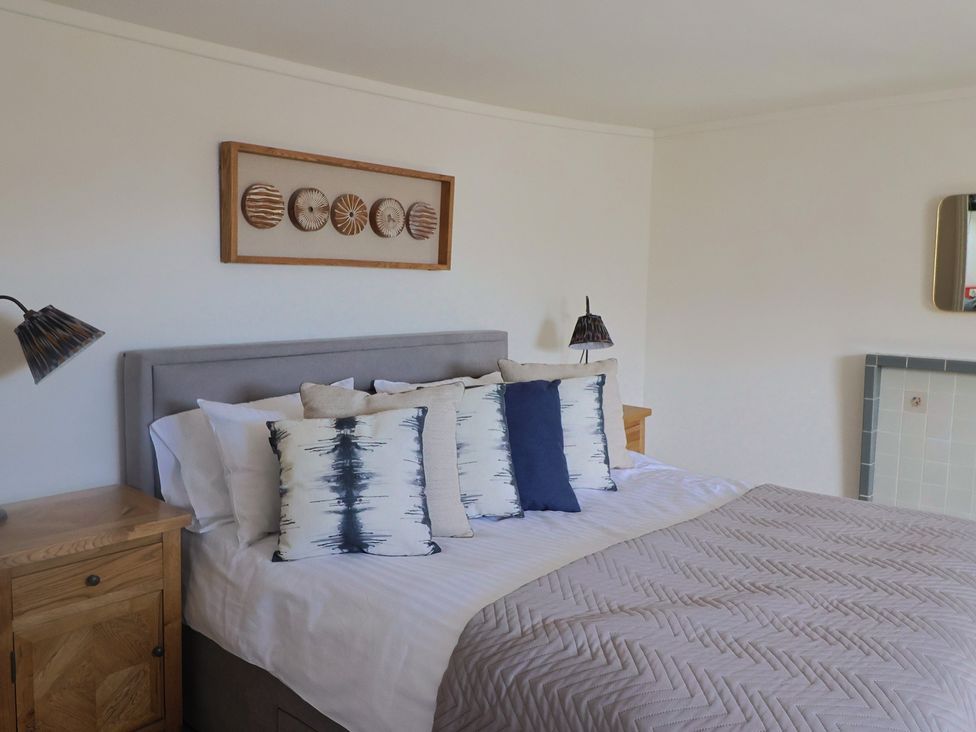 A bedroom with a bed and decorative pillows at FLAT 3 54a broad Street (2 bed sleeping 4) Lyme Regis