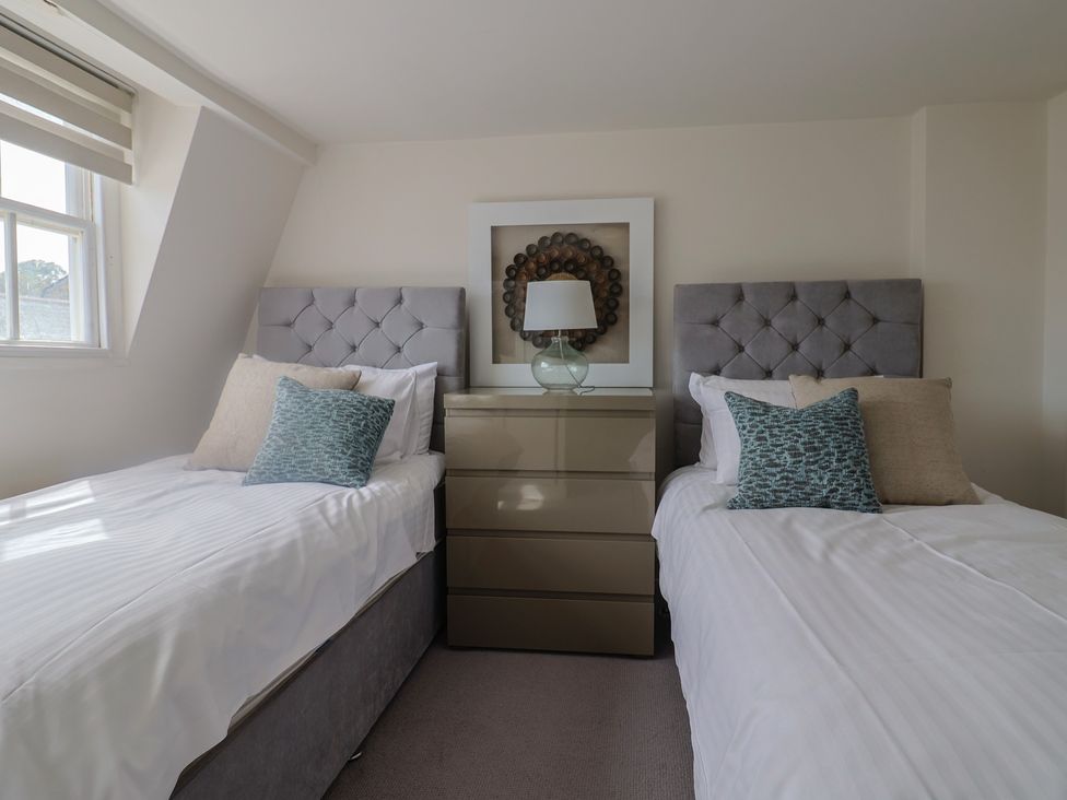 A bedroom with two single beds and a chest of drawers at FLAT 3 54a broad Street (2 bed sleeping 4) Lyme Regis