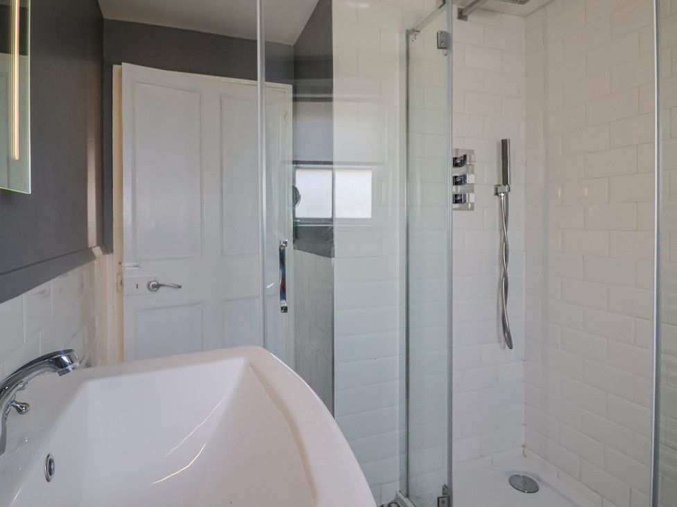 A bathroom with a bathtub and shower at FLAT 3 54a broad Street  (2 bed sleeping 4) Lyme Regis