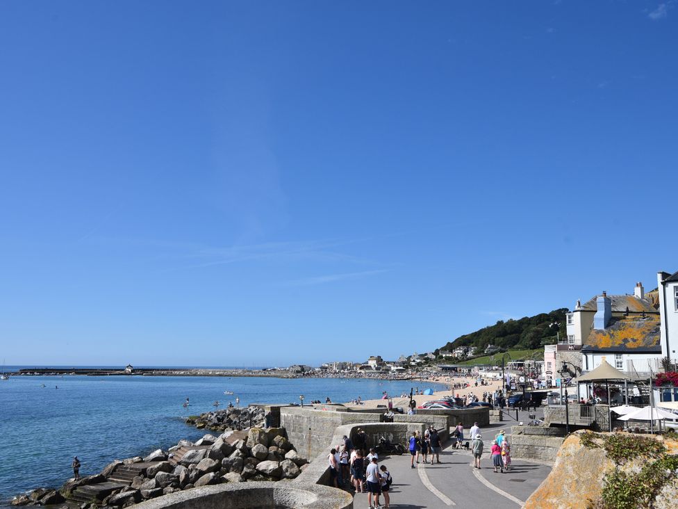 A view of a beach with people and buildings at FLAT 3 54a broad Street (2 bed sleeping 4) Lyme Regis