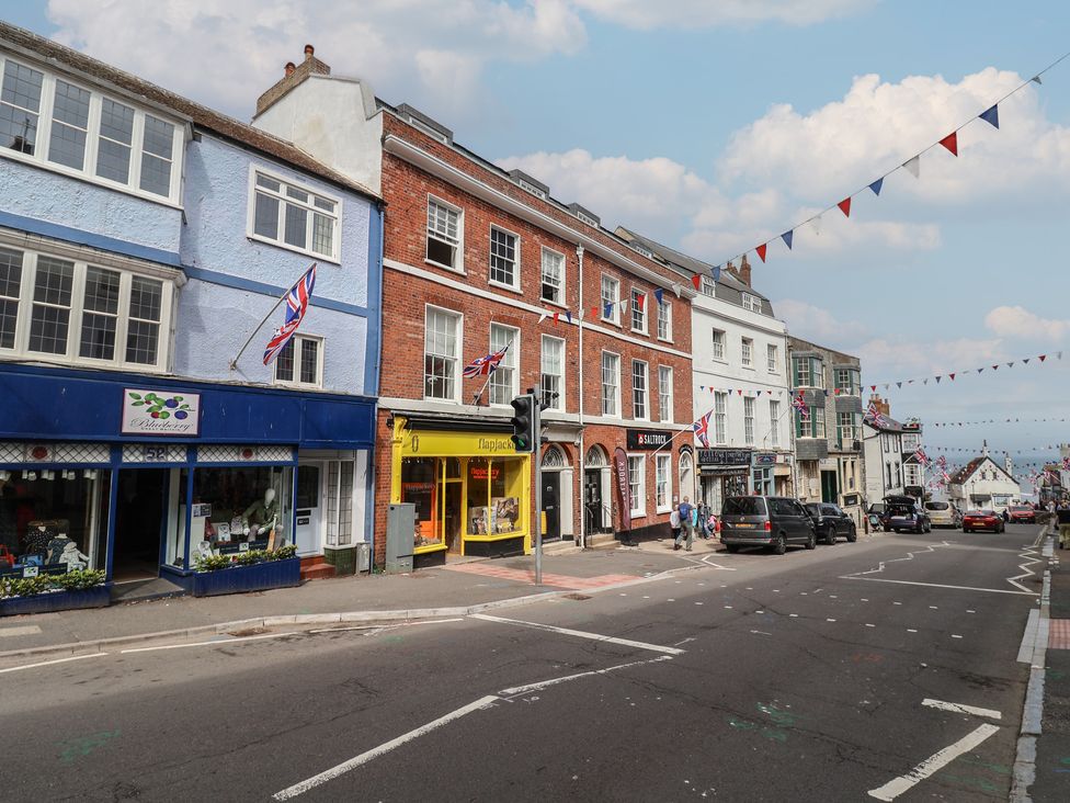 A street view with shops and flags at Flat 3 54A broad Street (2 bed sleeping 4) Lyme Regis