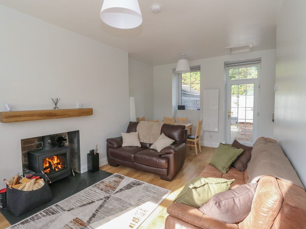 A living room with a sofa and fireplace at 8 Douglas Place