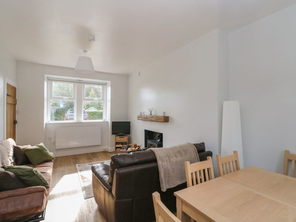 A living room with a sofa and table at 8 Douglas Place