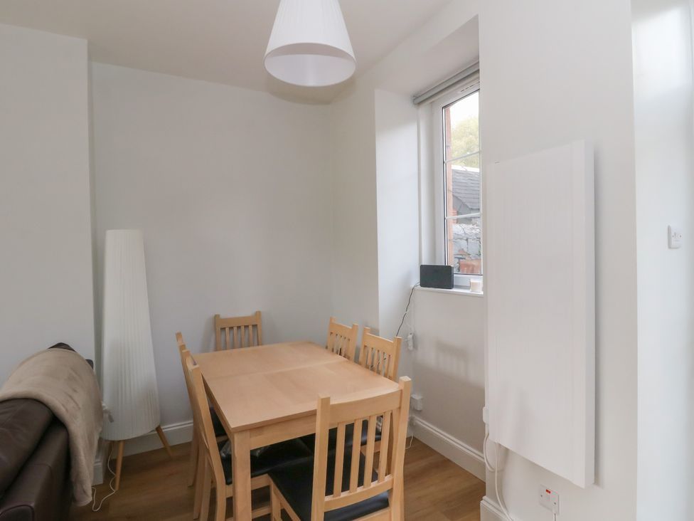 A dining room with a table and chairs at 8 Douglas Place
