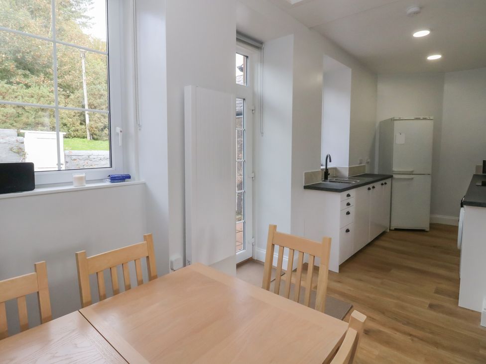 A kitchen with a dining table and chairs at 8 Douglas Place
