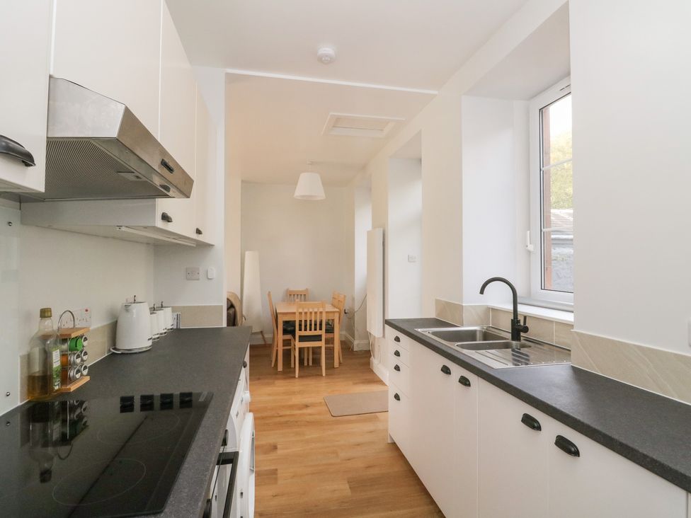 A kitchen with a sink and stove at 8 Douglas Place