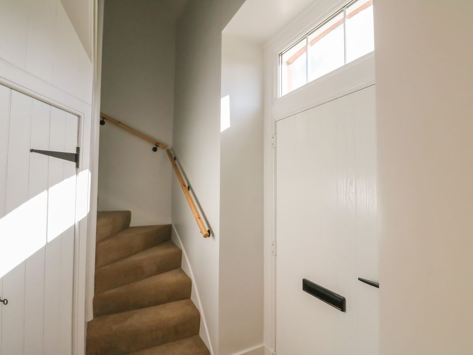 A staircase and door in a hallway at 8 Douglas Place