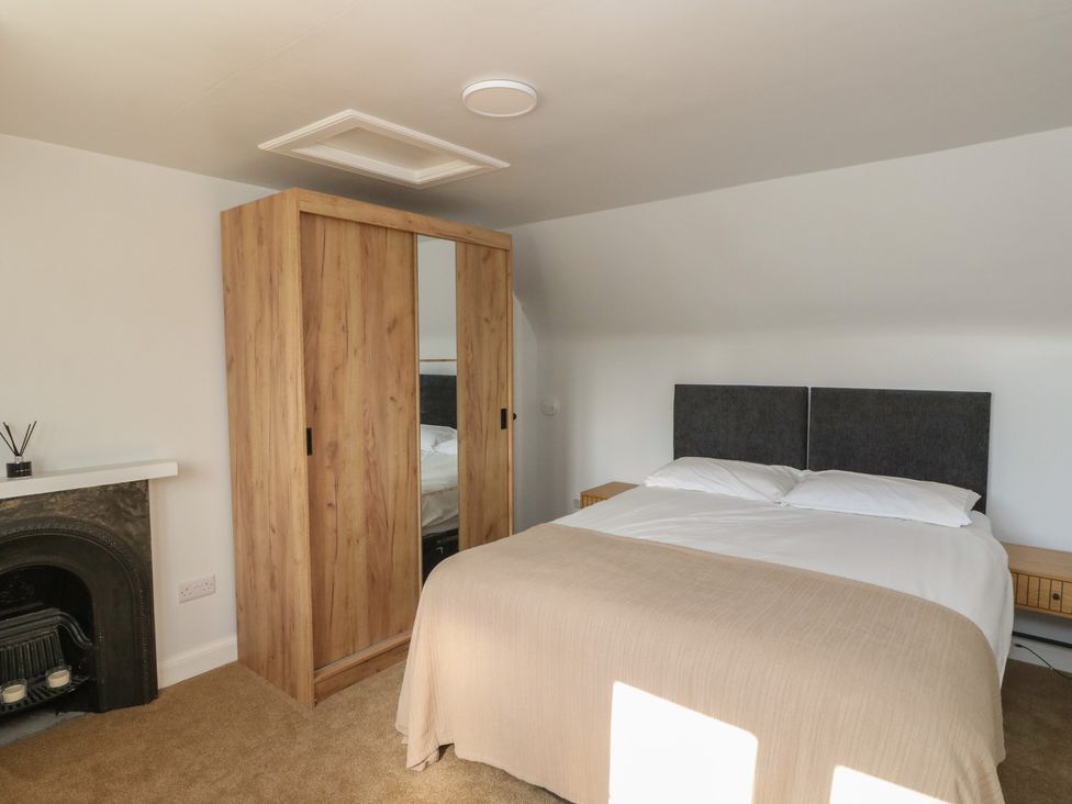 A bedroom with a bed and wardrobe at 8 Douglas Place