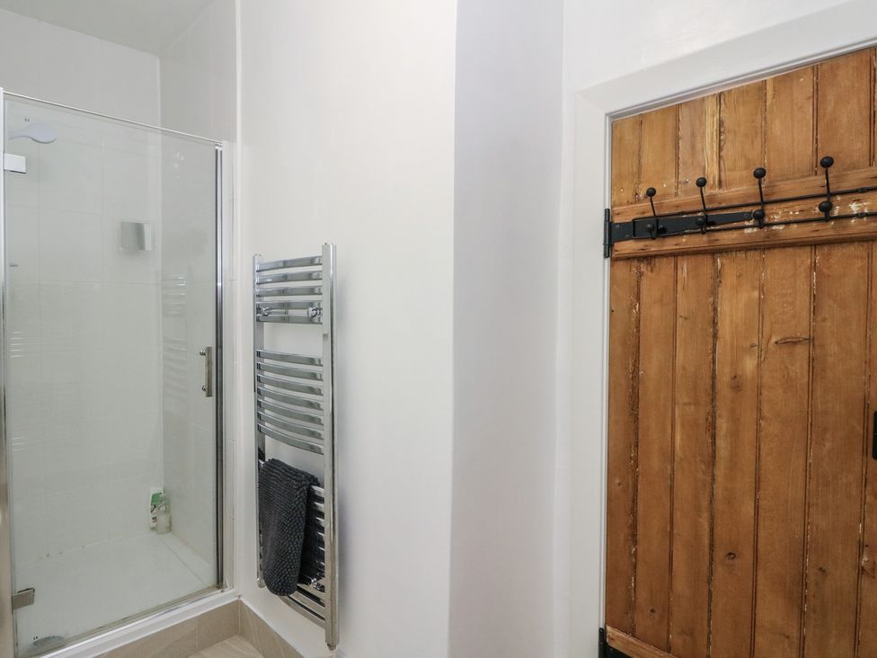 A bathroom with a shower and towel radiator at 8 Douglas Place