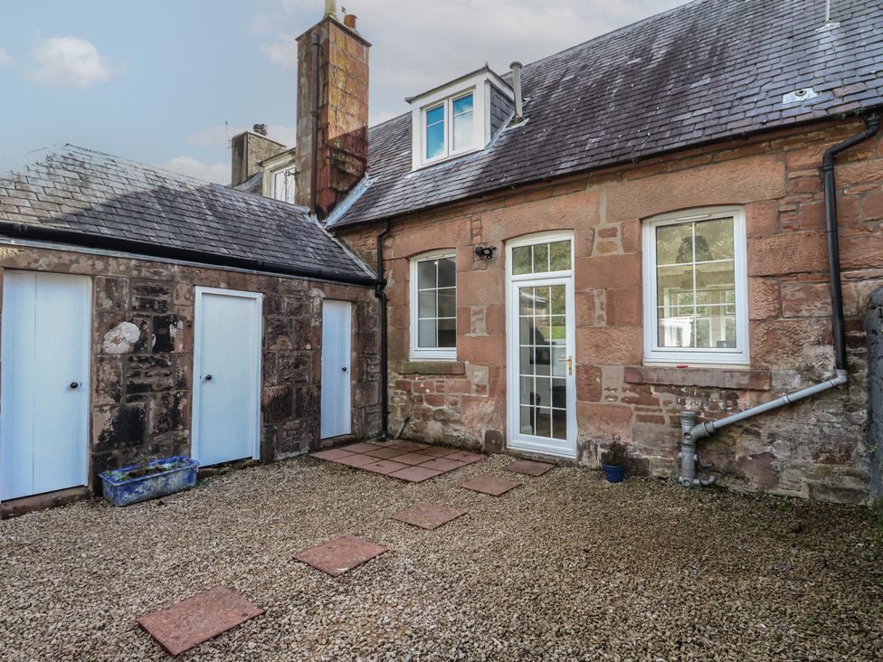 An outdoor area with stone walls and a garden path at 8 Douglas Place