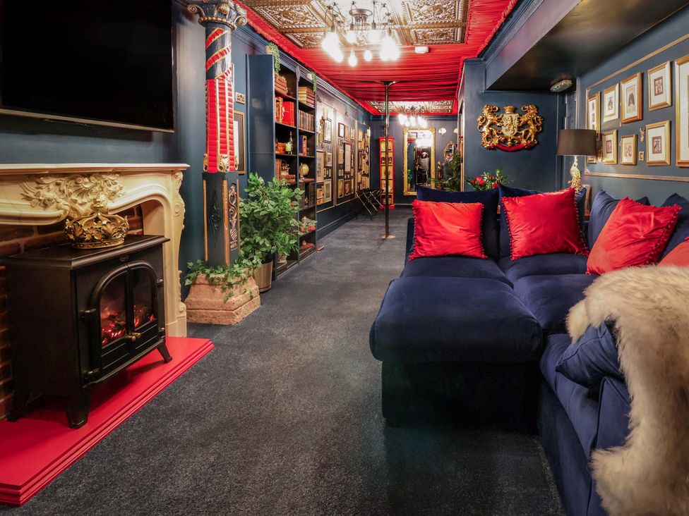 A living room with a fireplace and sofa at The Hollow in Holywell