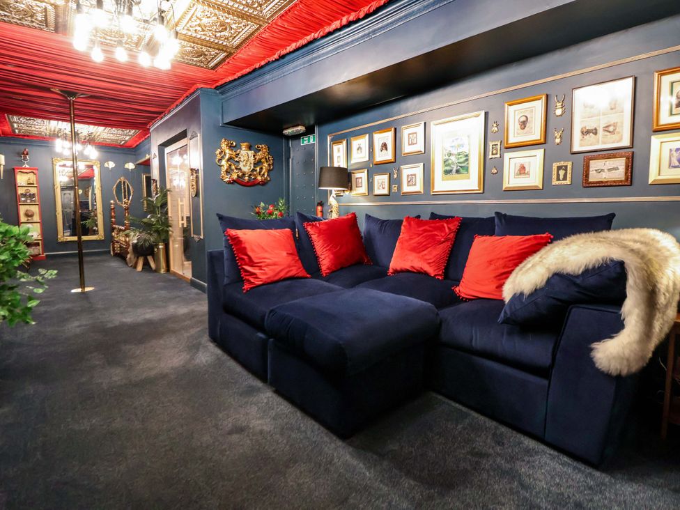 A living room with a sofa and wall decor at The Hollow in Holywell