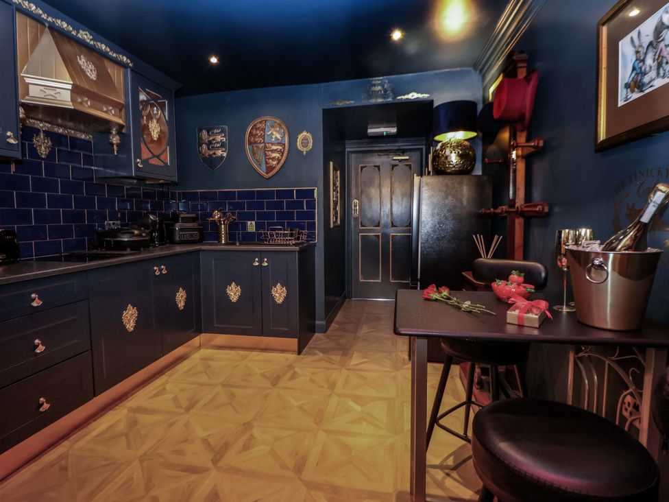 A kitchen with blue cabinets and a countertop at The Hollow in Holywell