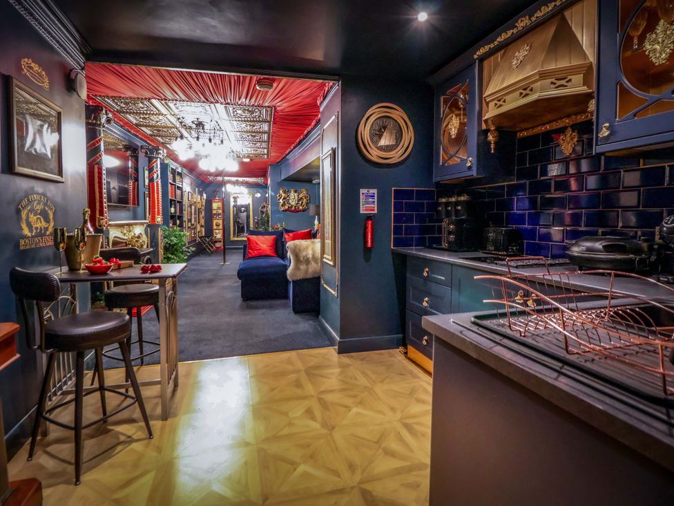 A kitchen with a bar area and decorative elements at The Hollow in Holywell