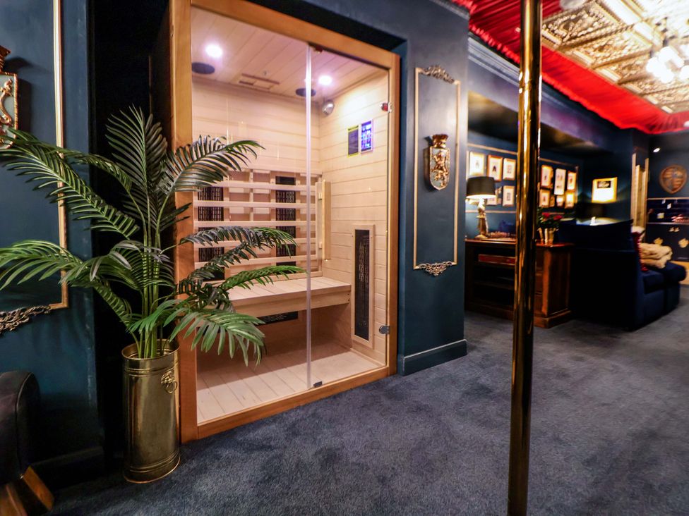 A sauna with a plant and a seating area at The Hollow in Holywell