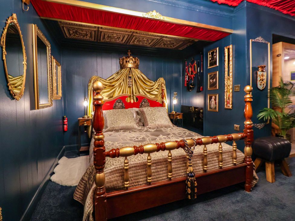 A bedroom with a bed and mirrors at The Hollow in Holywell