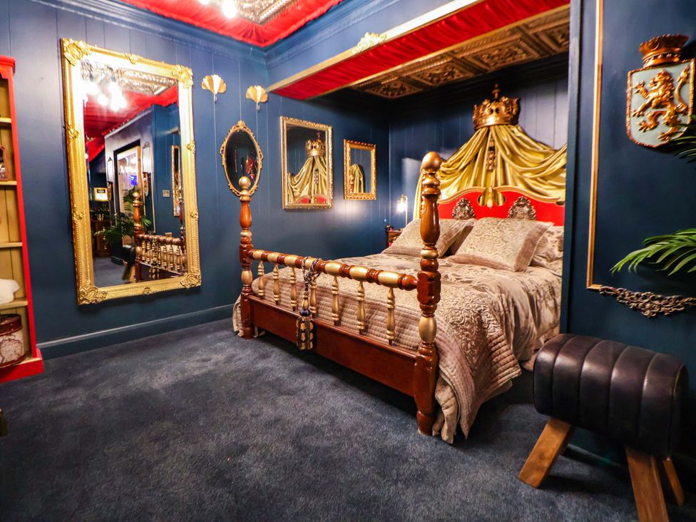 A bedroom with a bed and mirrors at The Hollow in Holywell