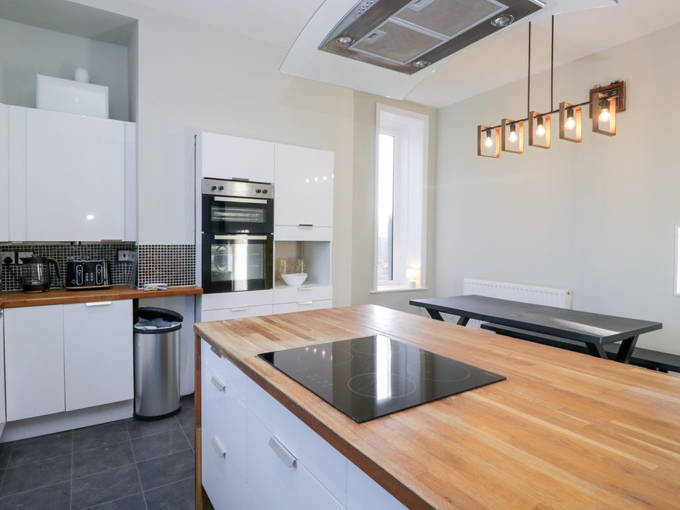 A kitchen with cabinets and appliances at Rocklands in Shap