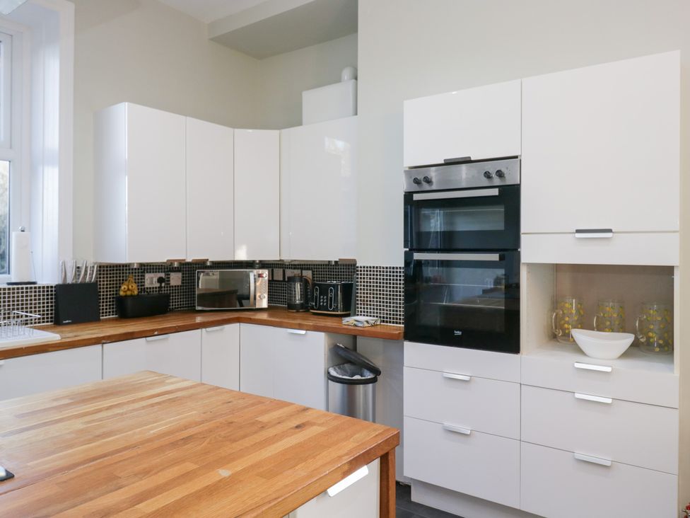 A kitchen with cabinets, appliances and a countertop at Rocklands in Shap