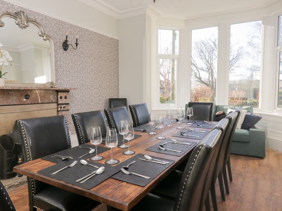 A dining room with a table set for dinner at Rocklands in Shap