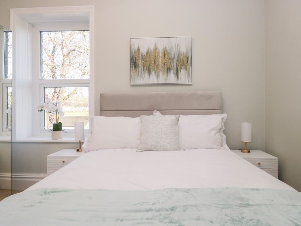 A bedroom with a bed and bedside table at Rocklands in Shap