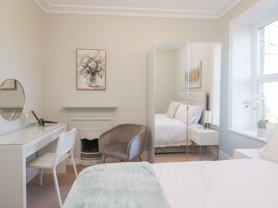 A bedroom with a bed and desk at Rocklands in Shap