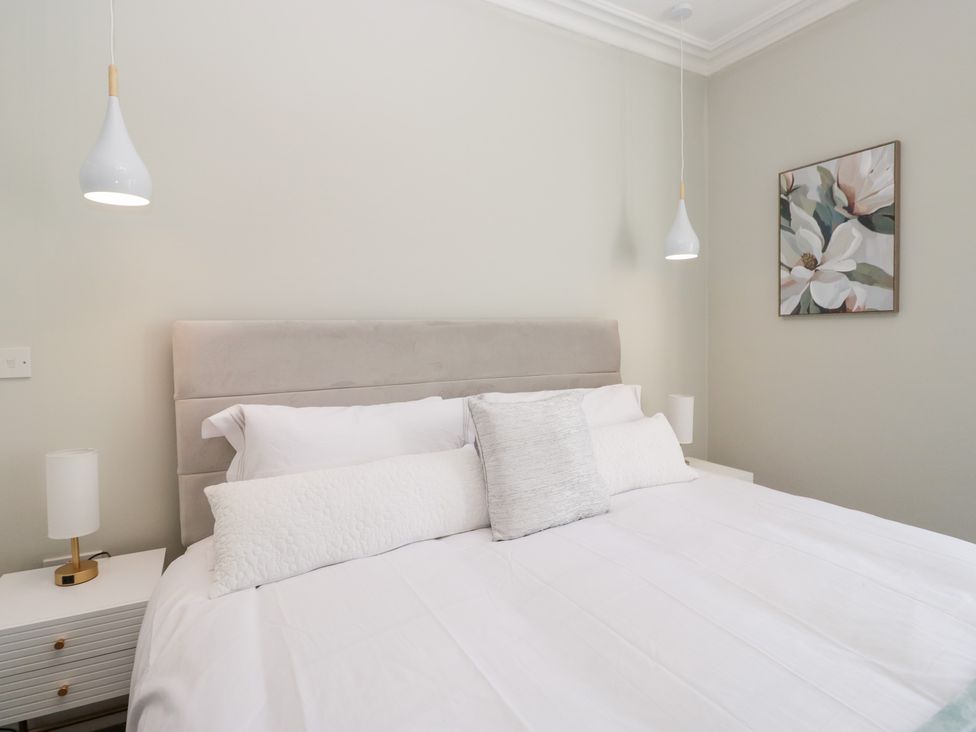 A bedroom with a bed and bedside lamp at Rocklands in Shap