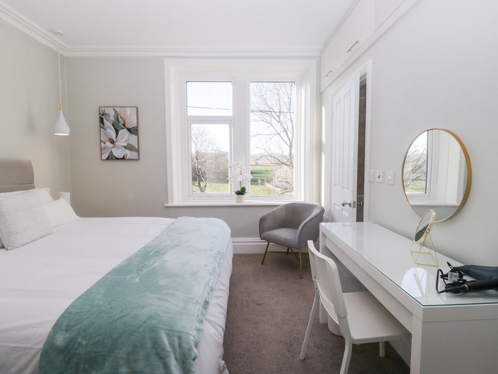A bedroom with a bed and a desk at Rocklands in Shap